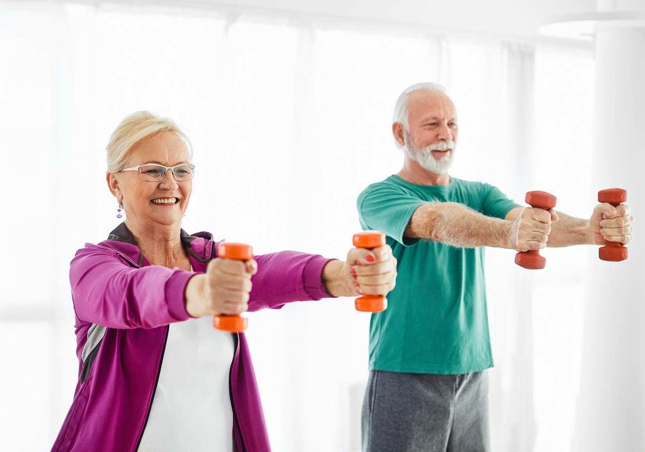 an older couple using free weights at home